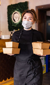 Asian woman carrying takeaway food packets for delivery