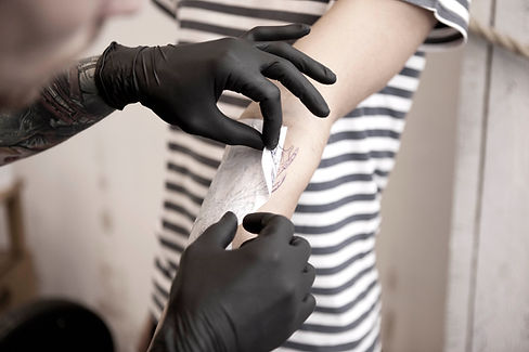 Tattoo Artist Removing Stencil