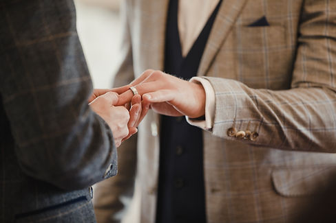 Groom exchanging wedding rings
