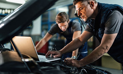 Technician performing mobile pre-purchase vehicle inspection on used car