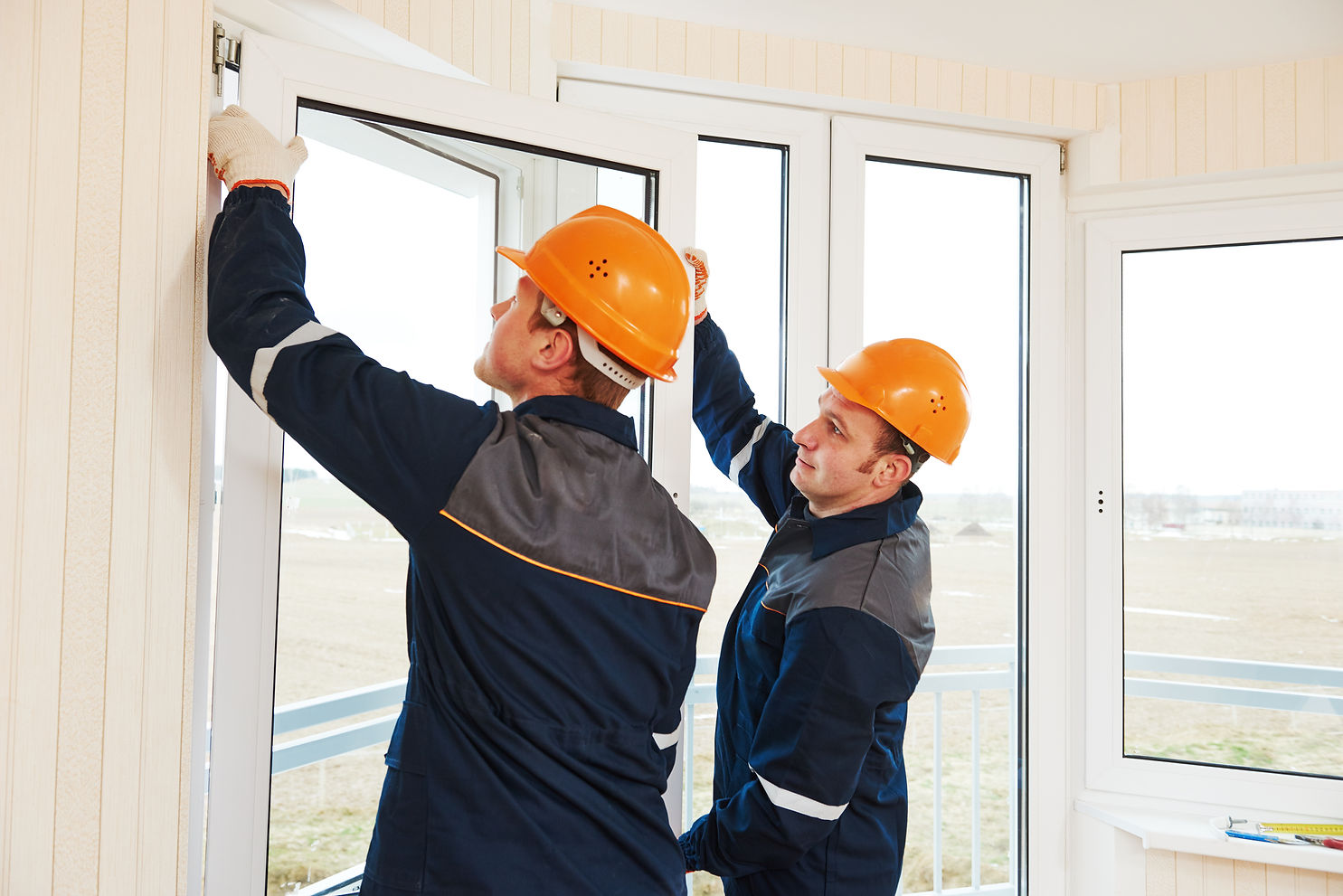 two windows installation workers installing double-glass pane