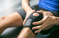 Close up of a therapist applying a massage tool to a person leg