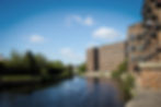 Large riverside apartment block, illustrating LivFinance's financing options for urban residential developments.