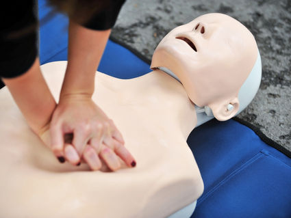 Hands resting on dummy
