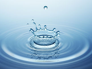 Water dropping onto a water surface creating a splash crown