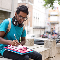 Student Writing Outdoors