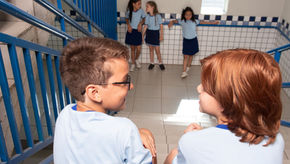 Two students in a hallway in school.