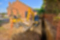 Home extension showing foundation trench and digger