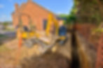 Home extension showing foundation trench and digger