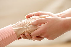 Befriender and client holding hands