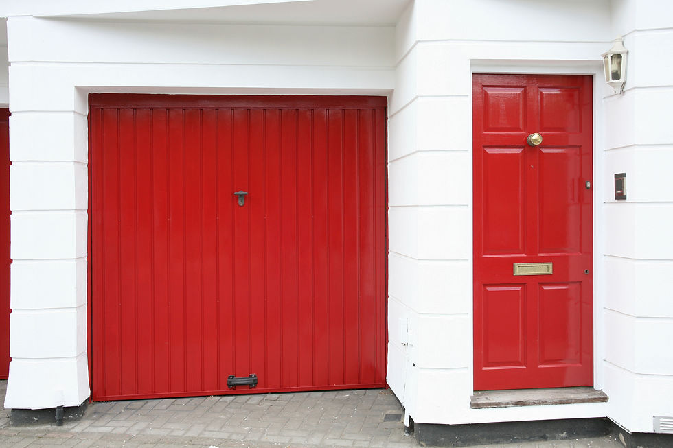 Red garage door and wooden front door with brass mail slot