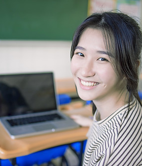 Smiling Student Sitting At Desk