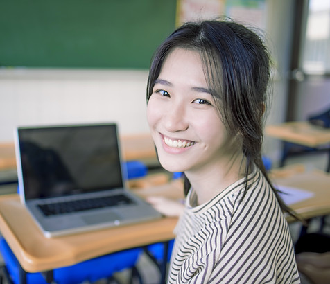 Smiling Student Sitting At Desk