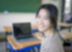 Smiling Student Sitting At Desk