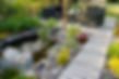 A beautiful small pond and a patio with a sitting area