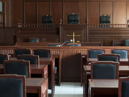 View of judges' bench down aisle in empty court room