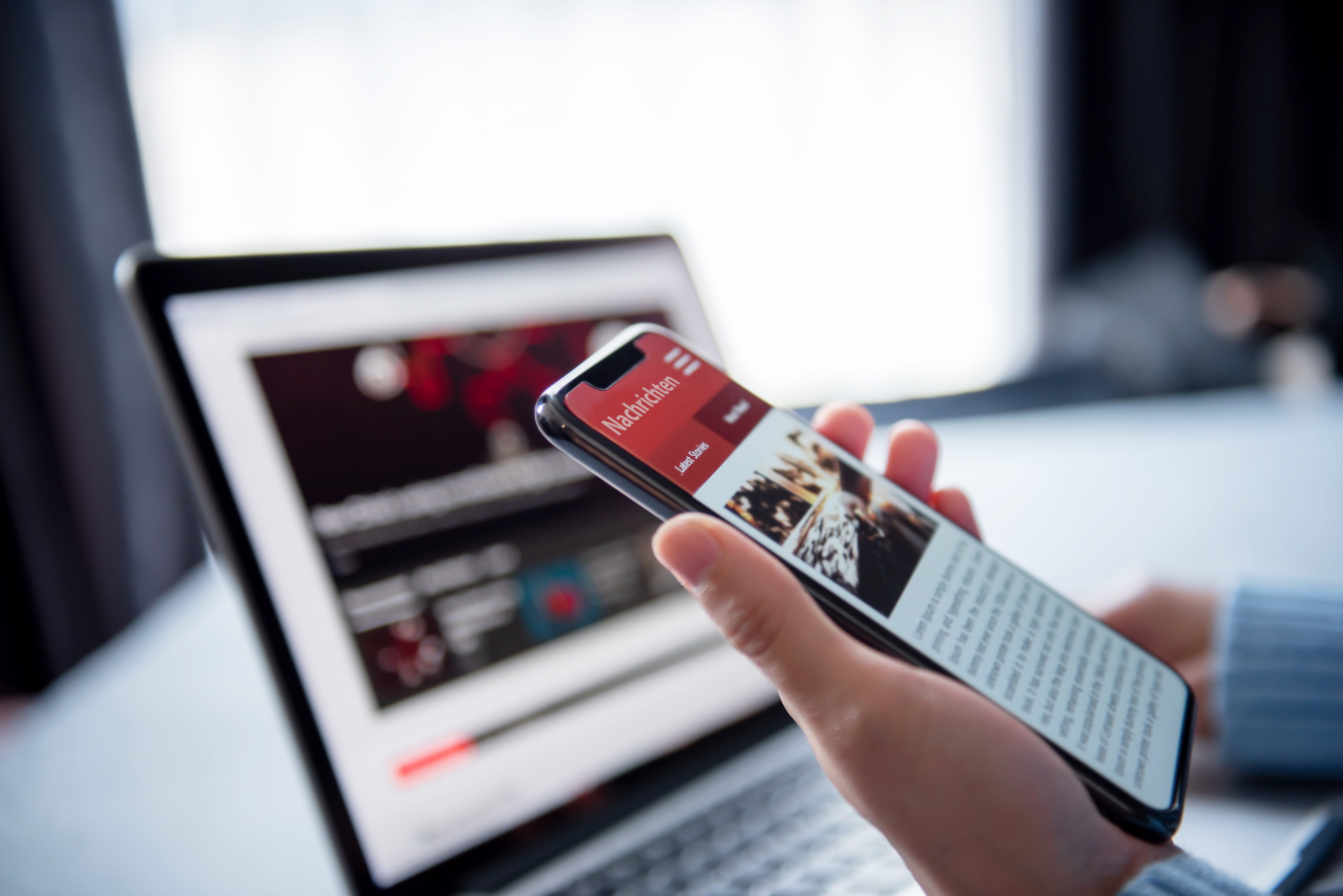 An image of a laptop and a mobile phone screen