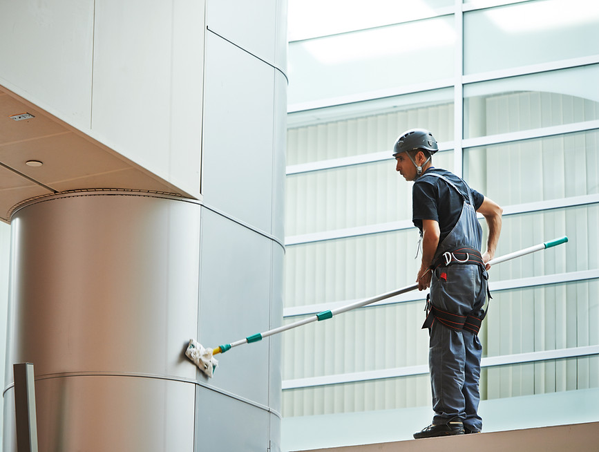 Worker Cleaning Wall