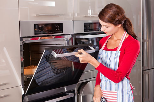 a woman checking the oven