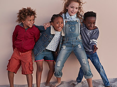 Cute Kids Posing Against Wall