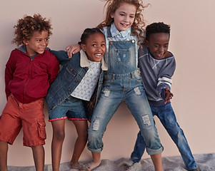 Cute Kids Posing Against Wall