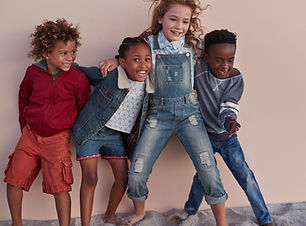 Cute Kids Posing Against Wall
