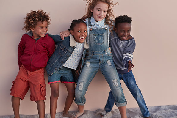 Cute Kids Posing Against Wall