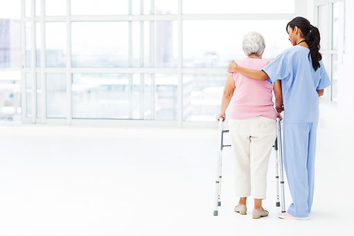 Carer walking alongside an elderly person to show domiciliary support