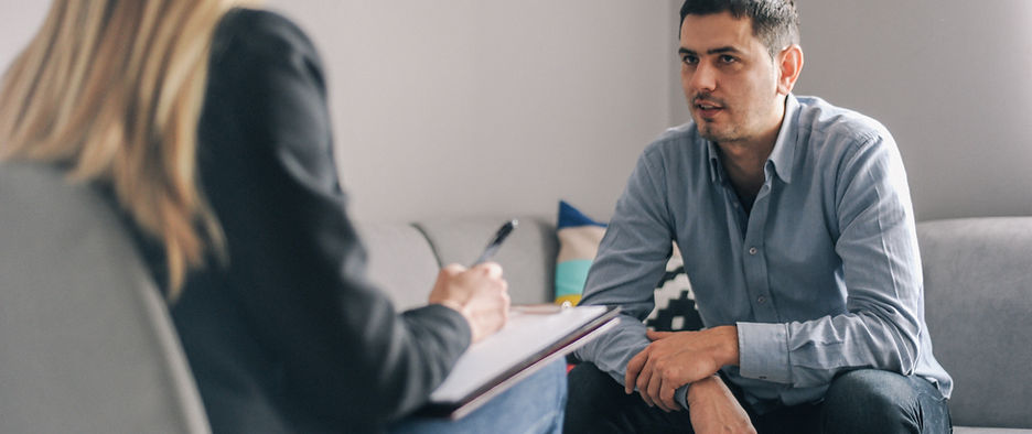 A female counselor talking to a male client