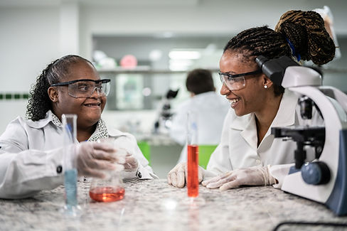 Teacher and child wave hello, the man watches in a colorful classroom.