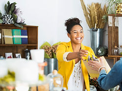 A salesperson handing a bag to a shopper