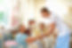 Side view of happy female caretaker assisting senior woman