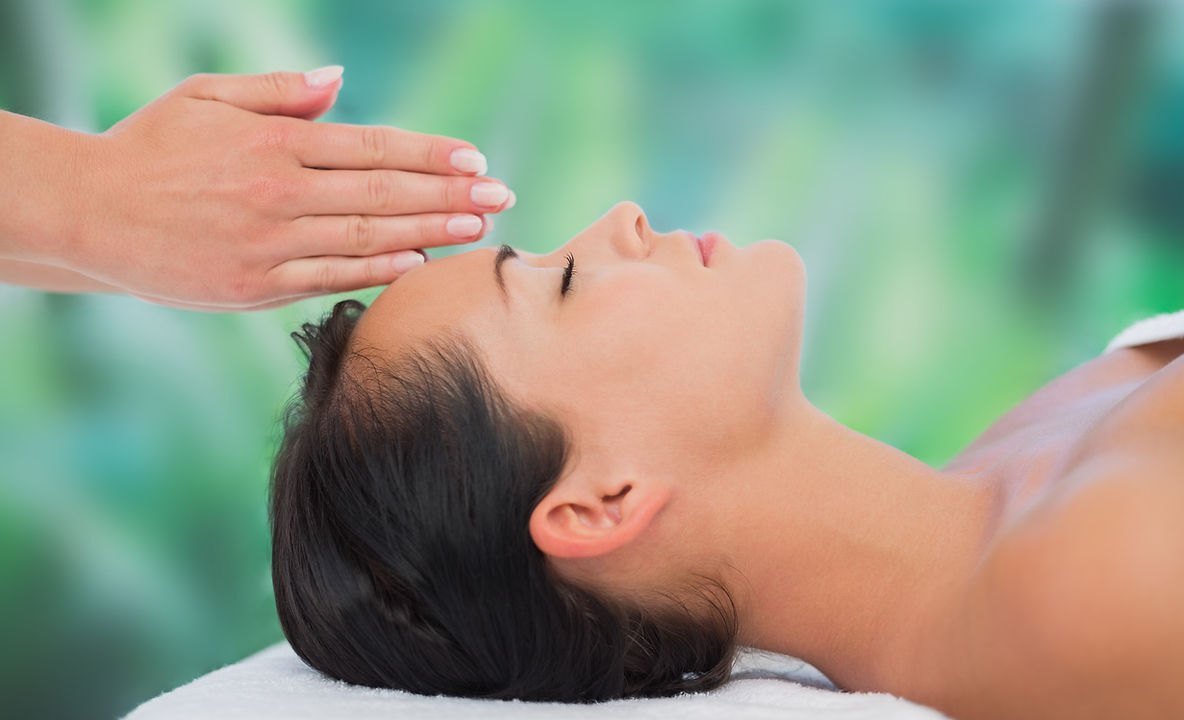 A young lady undergoing a head massage