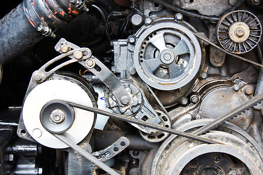Close-up view of a vehicle engine belt and pulley system