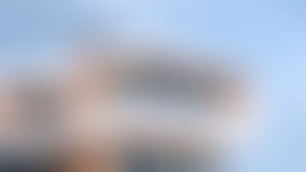 A luxurious, modern home with elegant outdoor seating and large windows, showcasing an inviting short-term rental property designed for guests seeking comfort and upscale amenities.