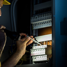 Electrician repairing electric panel