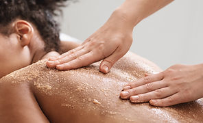 Gentle exfoliation with Maple Valley body scrub during a calming massage session, promoting natural skincare