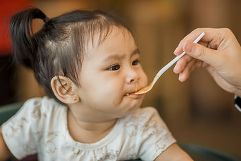 Spoon feeding a baby