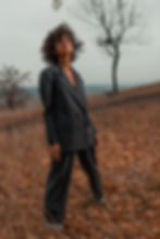 Woman standing in nature wearing a wool suit