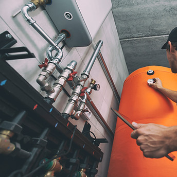 Technician Adjusting Boiler