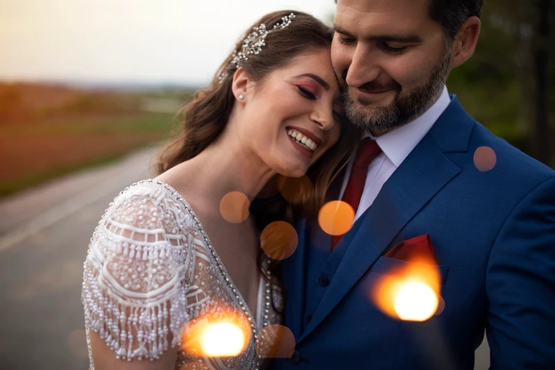 Happy newlyweds embrace after wedding.