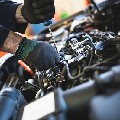 Close-up hands of unrecognizable mechanic doing car service and maintenance