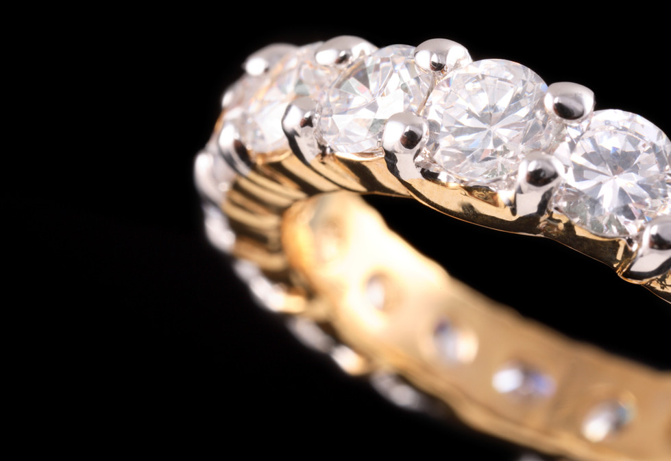 a close up of a diamond ring on a black background