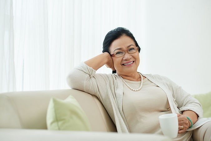 Old Asian woman comfortably posing