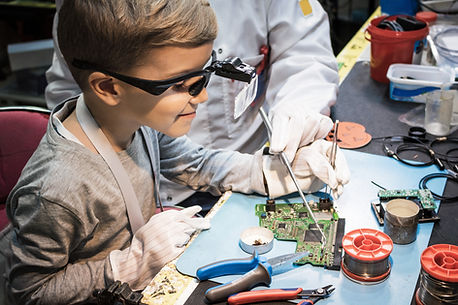 Boy Analyzing Circuit Board