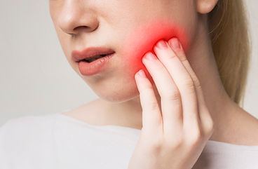 Woman suffering from toothache, touching inflamed cheek