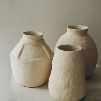Handmade ceramic vases in neutral tones displayed in a luxury London interior, reflecting natural materials and biophilic design principles.
