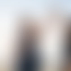 Two women in workout clothes high-five on a sunny beach after exercising, showing weight loss motivation and support during their fitness journey.