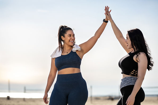 Women High-Fiving Outdoors