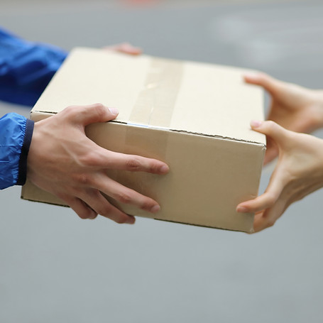 A package being exchanged between two people